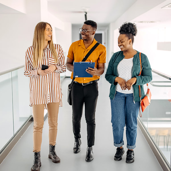 three-people-walking-hallway