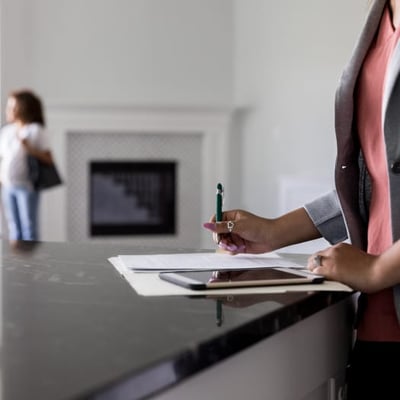 Person filling out paperwork on a table